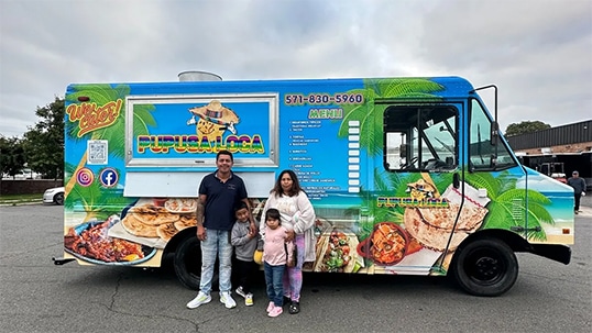 owner of pupusa loca food truck with his family in front of his new food truck