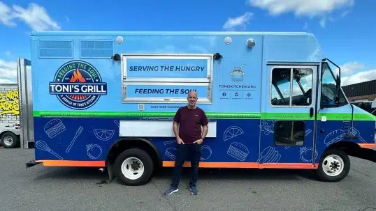 Toni standing in front of his new Toni's Grill food truck